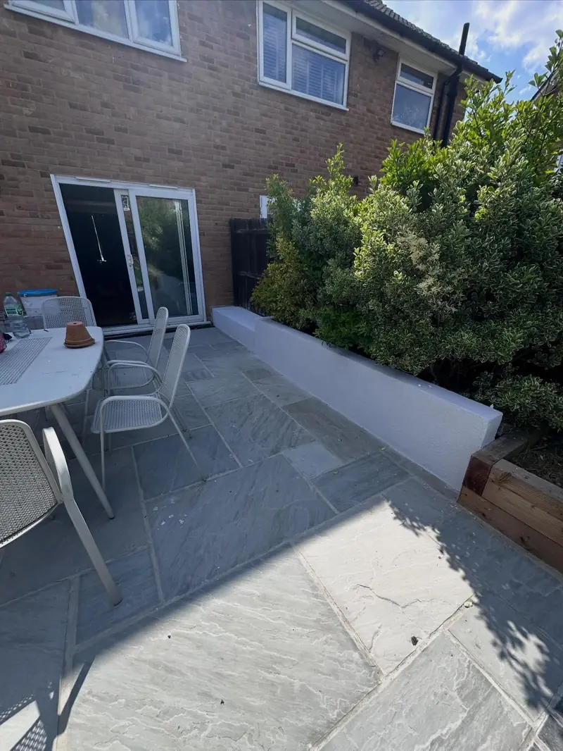 A Rainham garden with a rendered raised planter beside a new patio