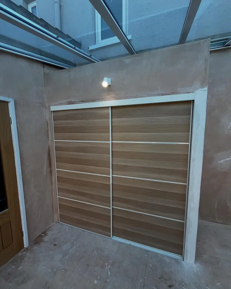 A lean-to in Upminster turned into a usable room, plastered with a fitted sliding wardrobe