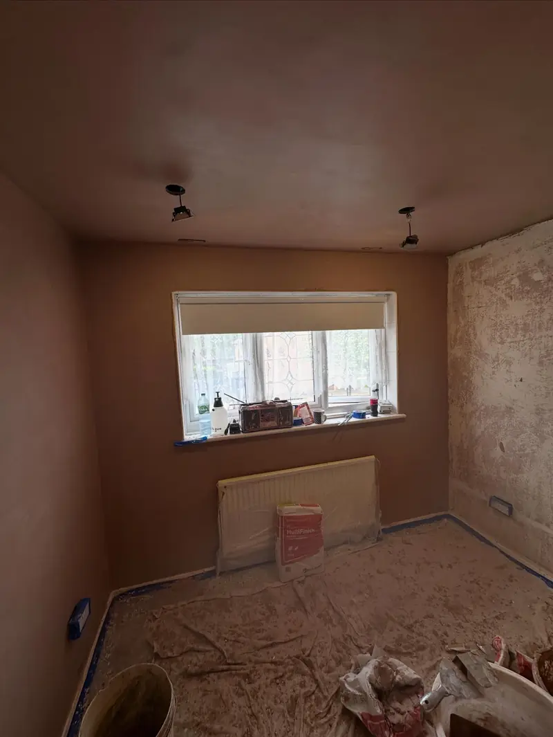 A bedroom in Rainham re-skimmed, with the floor sheeted