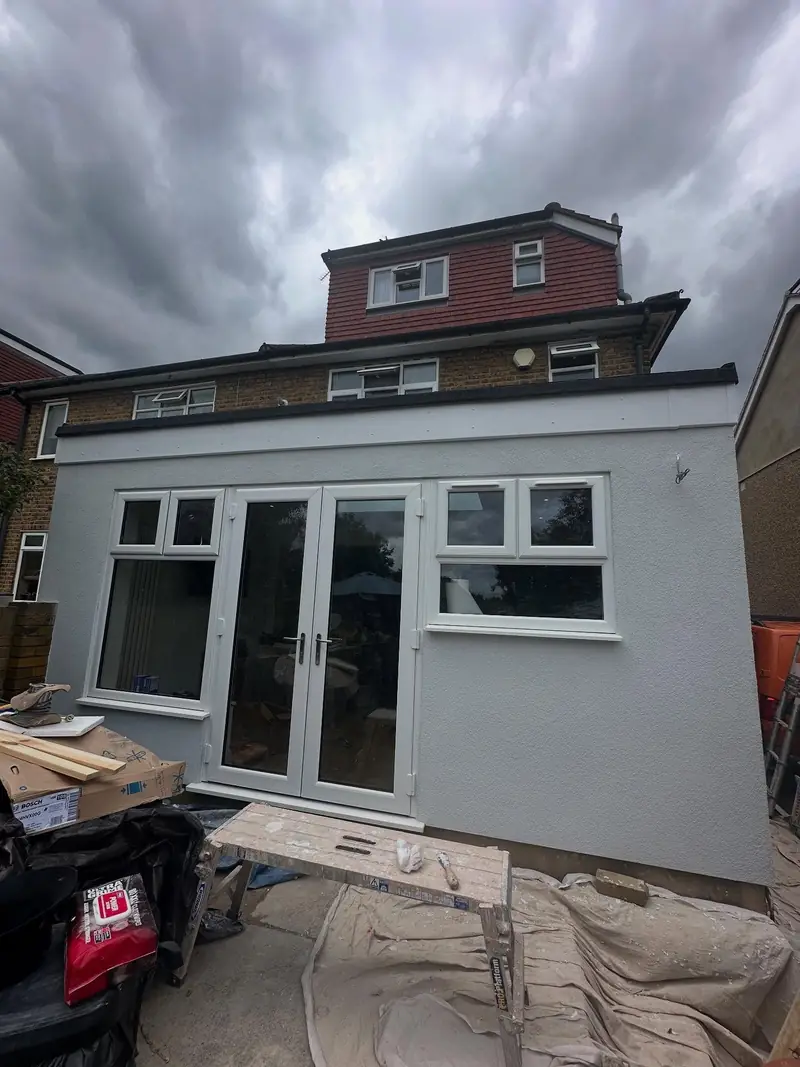 The back of a house in Upminster with its single-storey extension newly rendered in pale grey